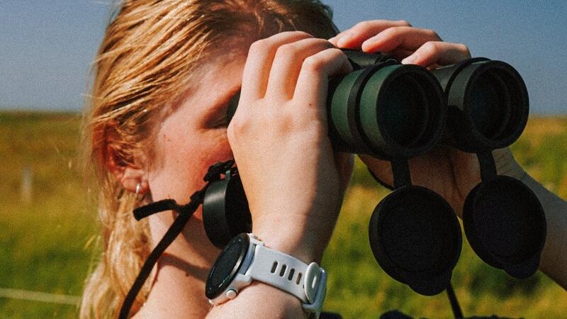 Young woman looking through binoculars. © Katharina Greitemann. Young woman looking through binoculars. © Katharina Greitemann.